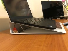 Image of binder used as a laptop stand with nonskid material to reduce sliding.